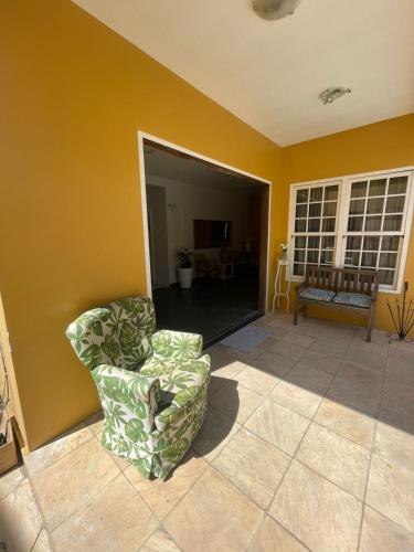 a living room with a chair and a couch at Pousada Casa Hospedaria in Paraty