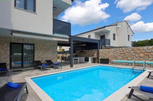 a swimming pool in the backyard of a house at Holiday house ZOROO with private pool in Sveti Anton