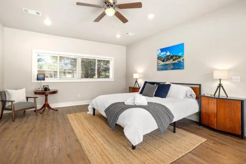 a bedroom with a bed and a ceiling fan at The George at 702 1 Mile to DT Springdale in Springdale