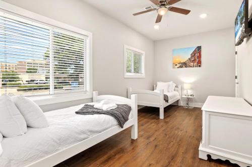 a white bedroom with a bed and a window at The George at 702 1 Mile to DT Springdale in Springdale