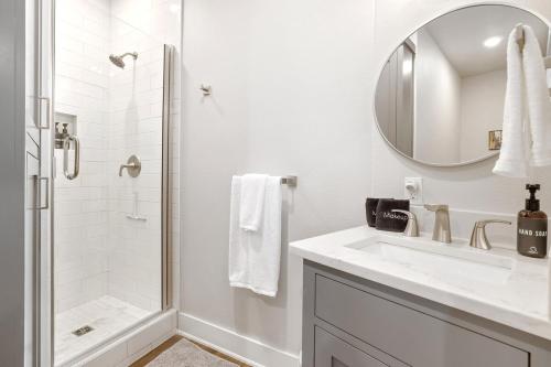 a white bathroom with a sink and a shower at The George at 702 1 Mile to DT Springdale in Springdale