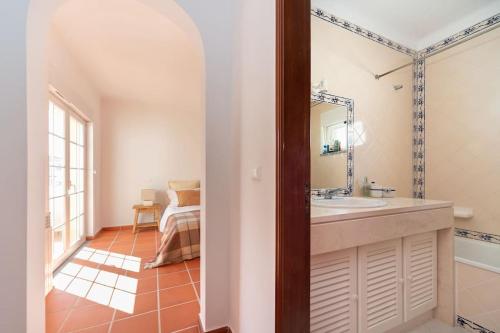 a bathroom with a sink and a mirror at Praia del Rey Golf & Beach Resort - T3 in Amoreira