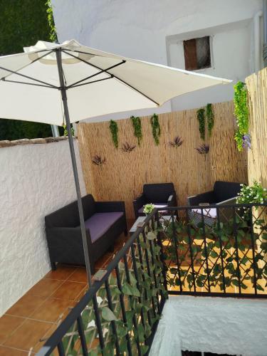 a white umbrella sitting on top of a patio at Cazorla Rural in Quesada
