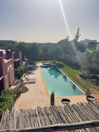 a view of a swimming pool in a yard at TARGANINE Lodge in Essaouira