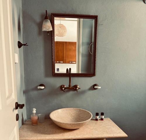 a bathroom with a bowl sink and a mirror at Akti Giannaki in Kardhianí