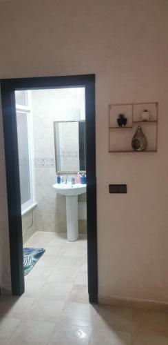 a bathroom with a sink and a mirror at Appartement résidence prive marina in Saidia 