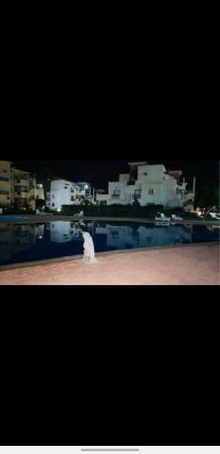 a water fountain in front of some white buildings at Appartement résidence prive marina in Saidia 