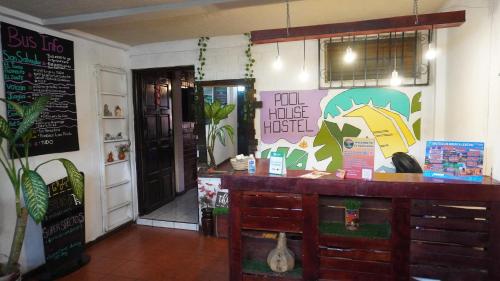 a fast food restaurant with a counter and an open door at Pool House Hostel in Santa Ana