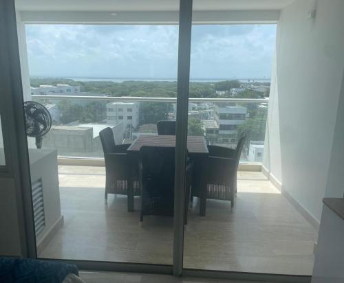 a dining room with a table and chairs on a balcony at Cartagena Beach comodo y agradable Aparta Suite in Cartagena de Indias
