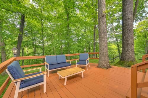 two chairs and a table on a deck with trees at Kentucky Getaway with Access to Rough River Lake! in Leitchfield