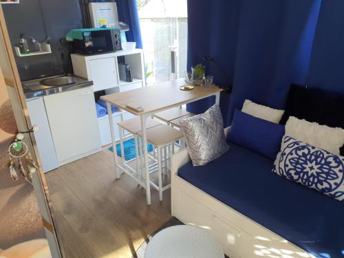 Habitación con sofá, mesa y cocina. en Spa Ibiza Dosrius, en Canyamars