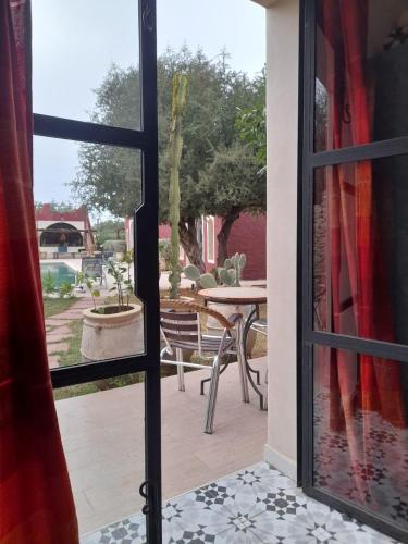 an open door to a patio with a table at TARGANINE Lodge in Essaouira