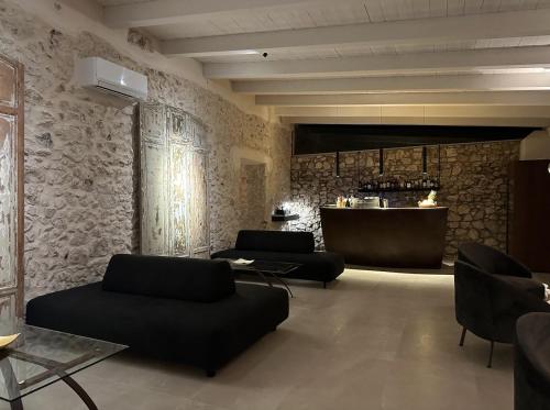 a living room with two couches and a bar at Baglio La Porta by Geocharme in San Vito lo Capo