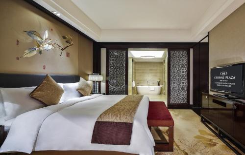 a bedroom with a large bed and a bathroom at Crowne Plaza Chengdu Panda Garden by IHG-Near Panda Base in Chengdu