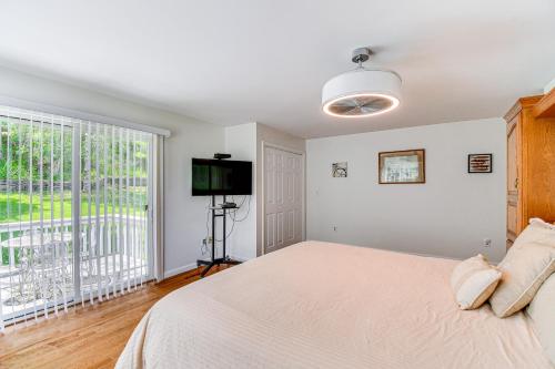 a bedroom with a bed and a large window at Montour Falls Home 2 Mi to Seneca Lake and Wineries in Montour Falls
