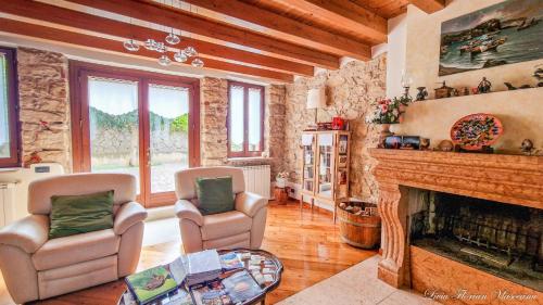 a living room with two chairs and a fireplace at B&B QUINTARELLI in San Pietro in Cariano