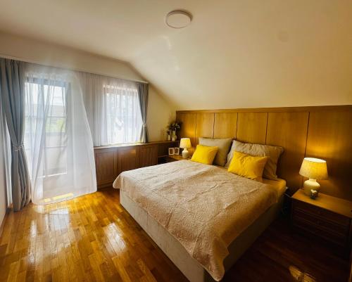 a bedroom with a large bed with yellow pillows at Landhaus Pannonia in Trausdorf an der Wulka