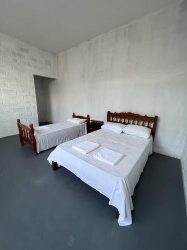 Ένα ή περισσότερα κρεβάτια σε δωμάτιο στο Apartamentos Itamaraty