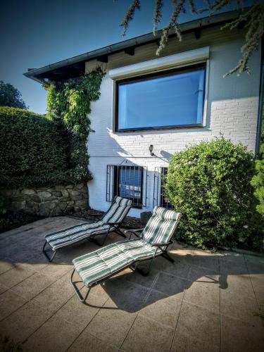 two lawn chairs sitting in front of a house at Silent Hill House in Bleckede