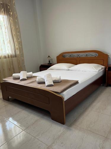 a bedroom with a bed with two towels on it at Guesthouse Dimitra in Paralia Dionysiou