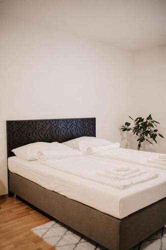 a bed with a white mattress in a room at Modern Apartments Vienna in Vienna