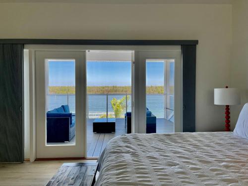 a bedroom with a bed and a view of the water at 3891 Bayside in Fort Myers Beach