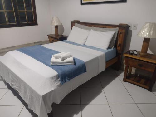 a bedroom with a bed with a towel on it at Pousada Robijn in Cabo de Santo Agostinho