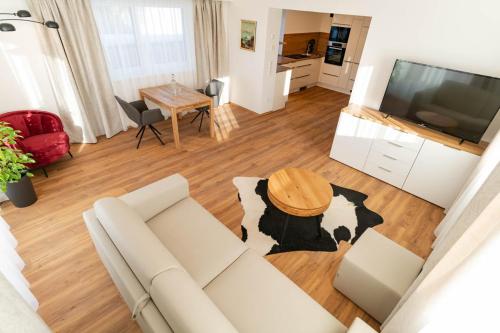 a living room with a couch and a table at Waldrand Apartments in Ramsau am Dachstein