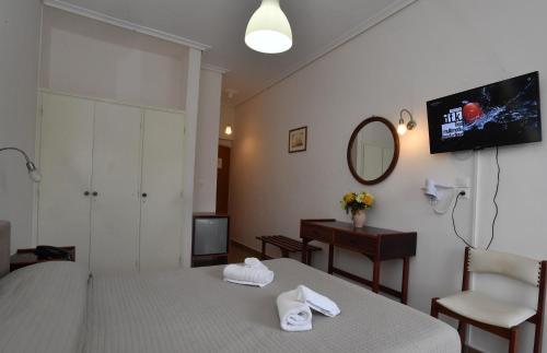 A bed or beds in a room at Siagas Beach Hotel