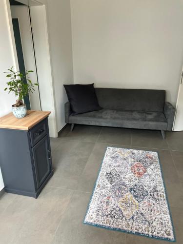 a living room with a couch and a rug at Westpark in Munich