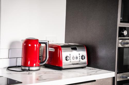 a red toaster sitting on top of a kitchen counter at Charming 1920s Villa on Bealey Ave in Christchurch