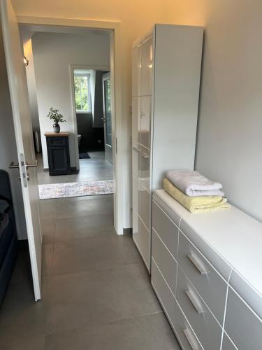 a bathroom with white cabinets and a walk in closet at Westpark in Munich