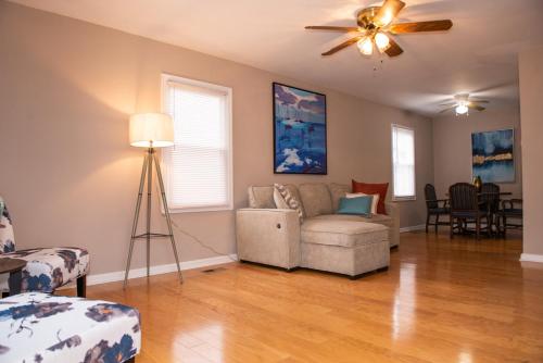 a living room with a couch and a ceiling fan at Perfect for families in Newport News