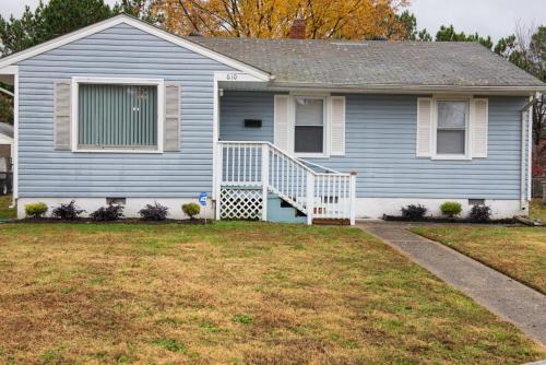a blue house with a white staircase in a yard at Perfect for families in Newport News