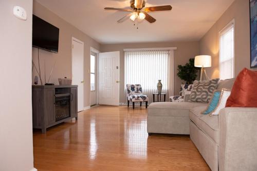 a living room with a couch and a ceiling fan at Perfect for families in Newport News