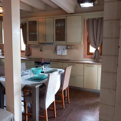 a kitchen with a table and chairs in a room at WOODEN HOUSE in Preveza