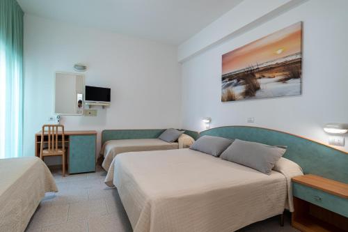 ベッラーリア・イジェア・マリーナにあるPiccolo Hotelのベッド2台とソファが備わるホテルルームです。