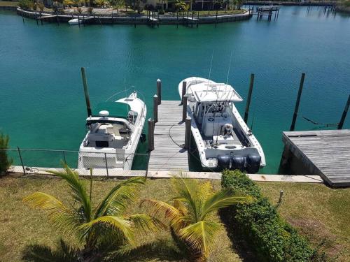 two boats docked at a dock in the water at Beautiful 3 Bed 3 & a half Bath Home with Pool & Dock Slip in Freeport