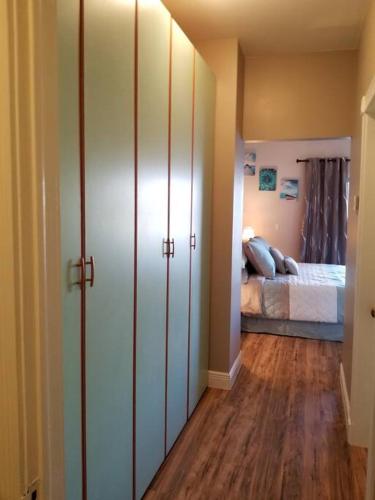 a room with a bedroom with a bed and wooden floors at Beautiful 3 Bed 3 & a half Bath Home with Pool & Dock Slip in Freeport