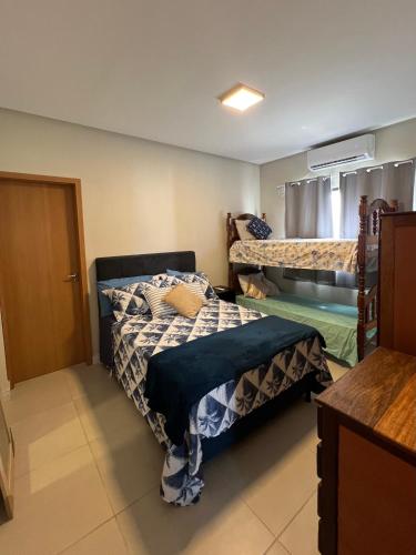 a small room with two beds and a door at Casa ampla na Praia do Atalaia Salinas Pará in Salinópolis