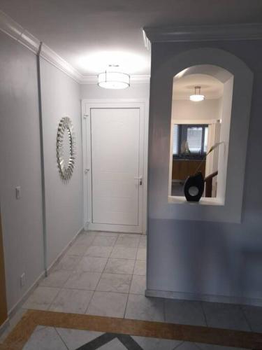 a hallway with a white door and a mirror at Beautiful 3 Bed 3 & a half Bath Home with Pool & Dock Slip in Freeport