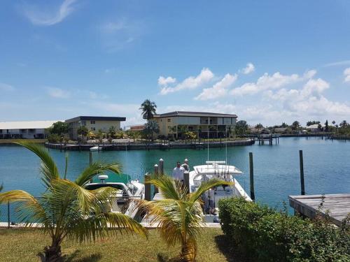 two people standing on a boat in the water at Beautiful 3 Bed 3 & a half Bath Home with Pool & Dock Slip in Freeport