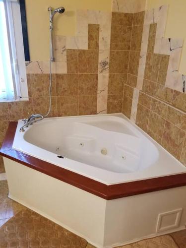 a large white bath tub in a bathroom at Beautiful 3 Bed 3 & a half Bath Home with Pool & Dock Slip in Freeport