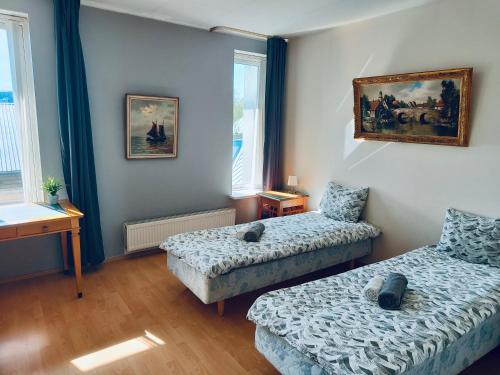 a room with two beds and a couch and a table at Tallinn Seaside Apartment in Tallinn