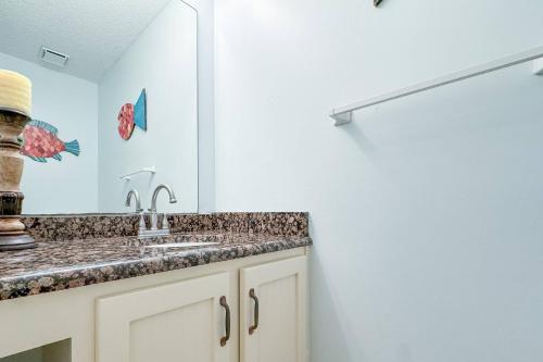 a bathroom with a sink and a mirror at Beach Club C-102 in Gulf Highlands