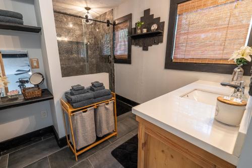 a bathroom with a tub and a sink and a shower at New Listing! Boho Mountain Getaway - 2 Bed, 2 Bath in Dahlonega