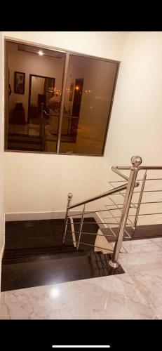 a metal staircase in a building with a mirror at Family stay at Bahria KHI in Karachi