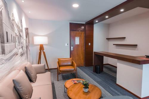 a living room with a couch and a table at Hotel Cortez in Santa Cruz de la Sierra