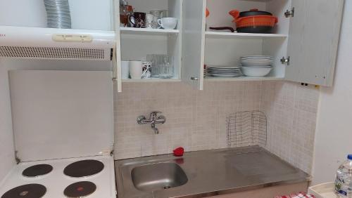 a kitchen with a sink and a counter top at Kastoria apartment μπροστά στη λίμνη στο κέντρο in Kastoria