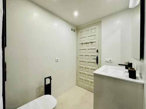 a white bathroom with a sink and a toilet at Mimoses CostaBravaSi in Sant Feliu de Guíxols